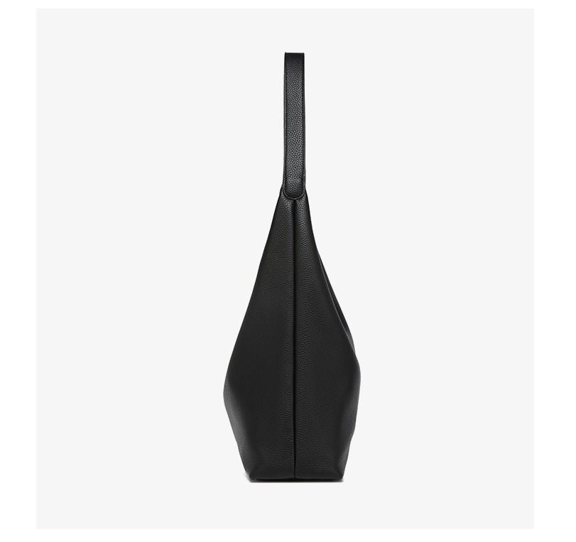 Black pebble-leather tote bag with long shoulder strap, side profile.